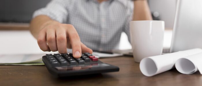 Business owner using calculator