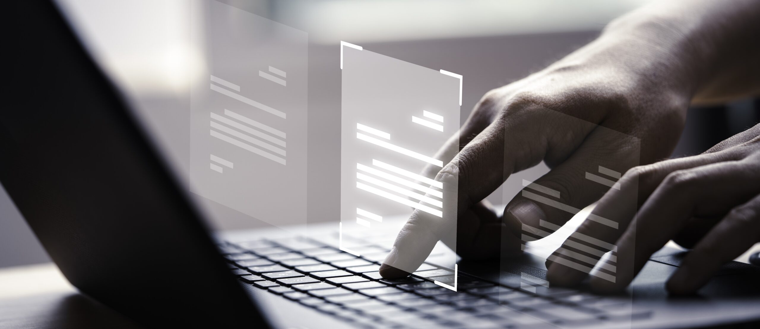 Hand using laptop computer with virtual screen and document for online approve paperless quality assurance and ERP management concept.