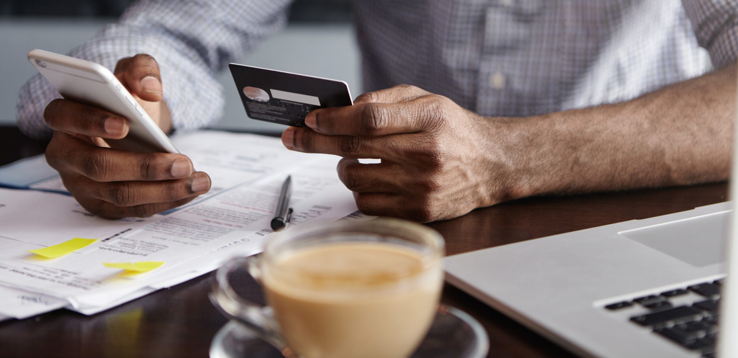 Close up shot of man viewing bank balance and holding mobile phone