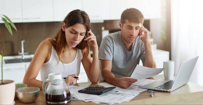 Couple reviewing company debts