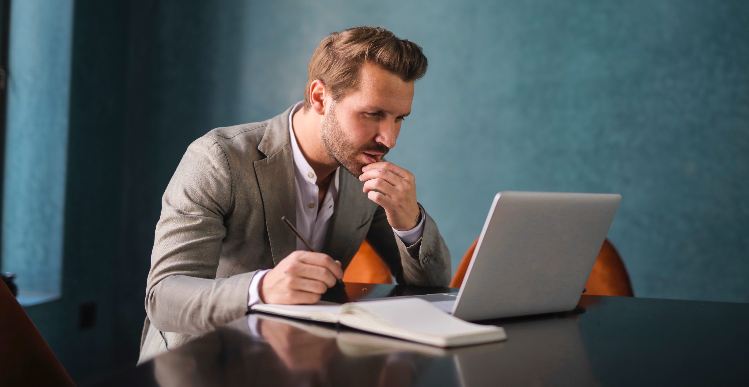Confused business man looking at laptop